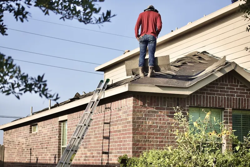 Professional roofer working on a residential roof in First Hill
